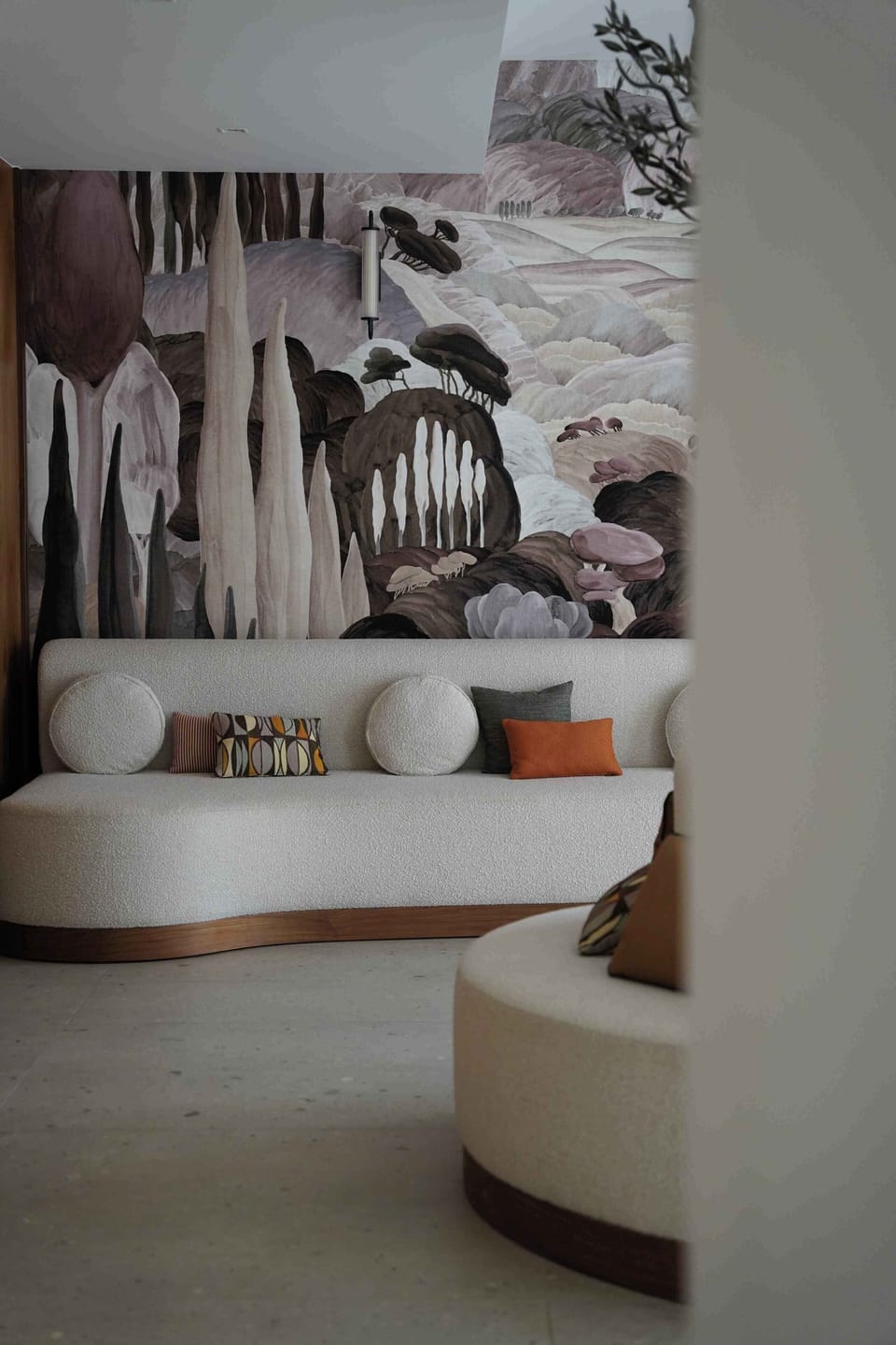 A wooden bookshelf with a potted plant adds a quiet reading corner to the common area