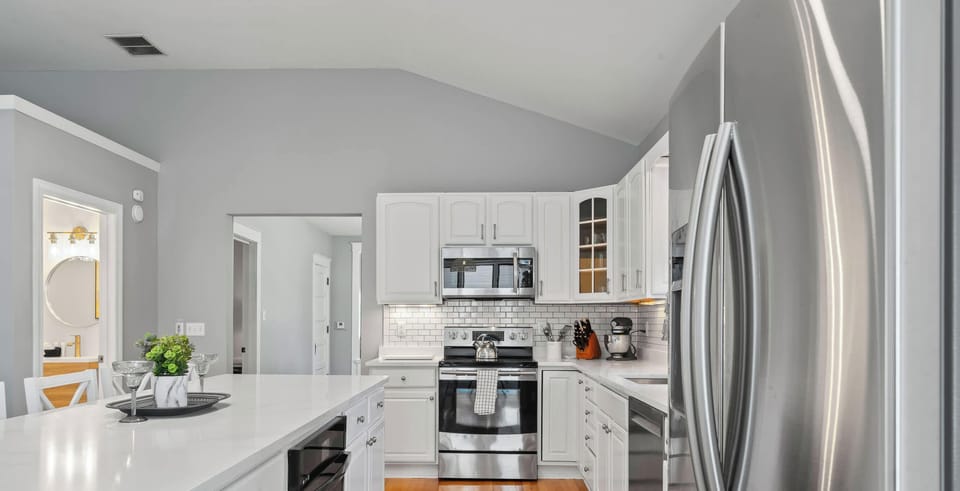 ✨ Sleek white cabinetry & professional appliances — thoughtfully designed so you spend less time cooking and more time together.