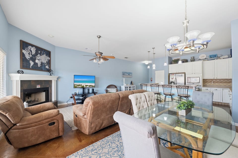 Relax in your spacious open-concept living area, where cozy seating, and modern kitchen flow seamlessly together for memorable gatherings.
