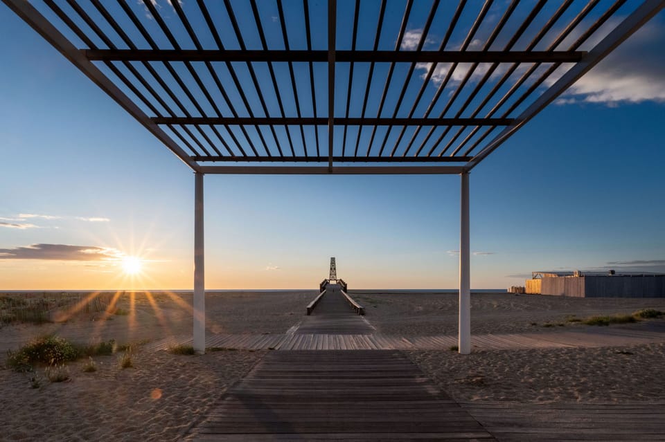 Sunset through the beach pergola — golden evenings on the doorstep of the residence.