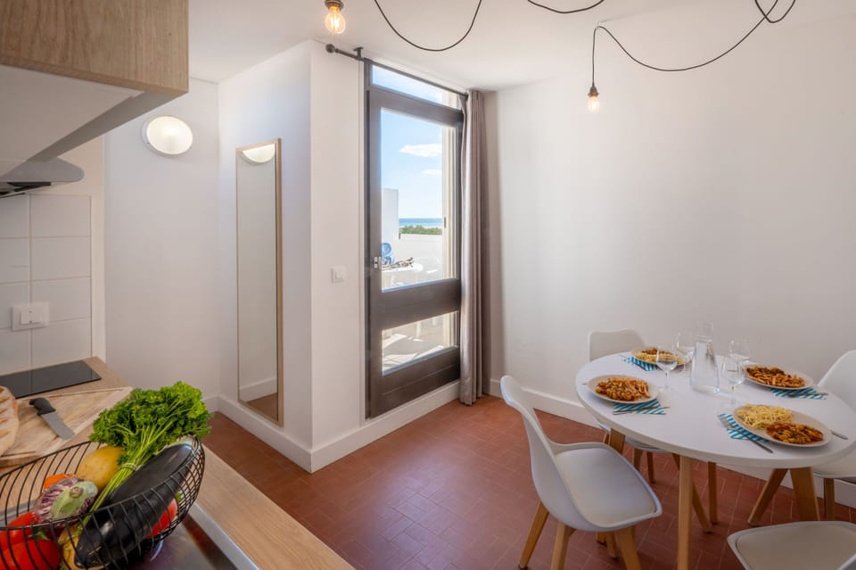 The dining area with terrace access — al fresco meals for the whole group just a step away.