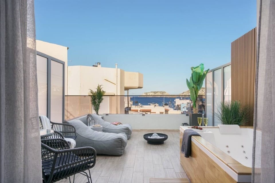 Relax in the outdoor heated hot tub with sea view, perfect for any season.