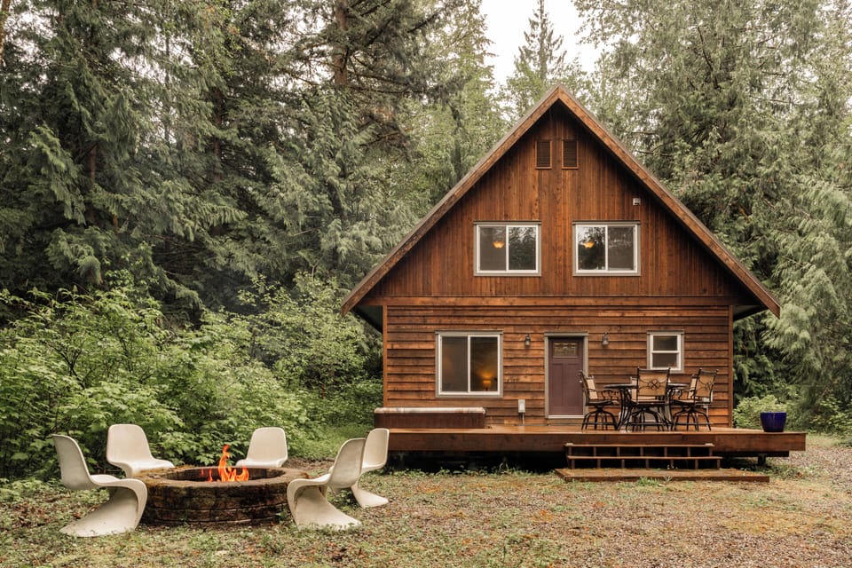 Backyard setting with fire pit, deck dining, and hot tub