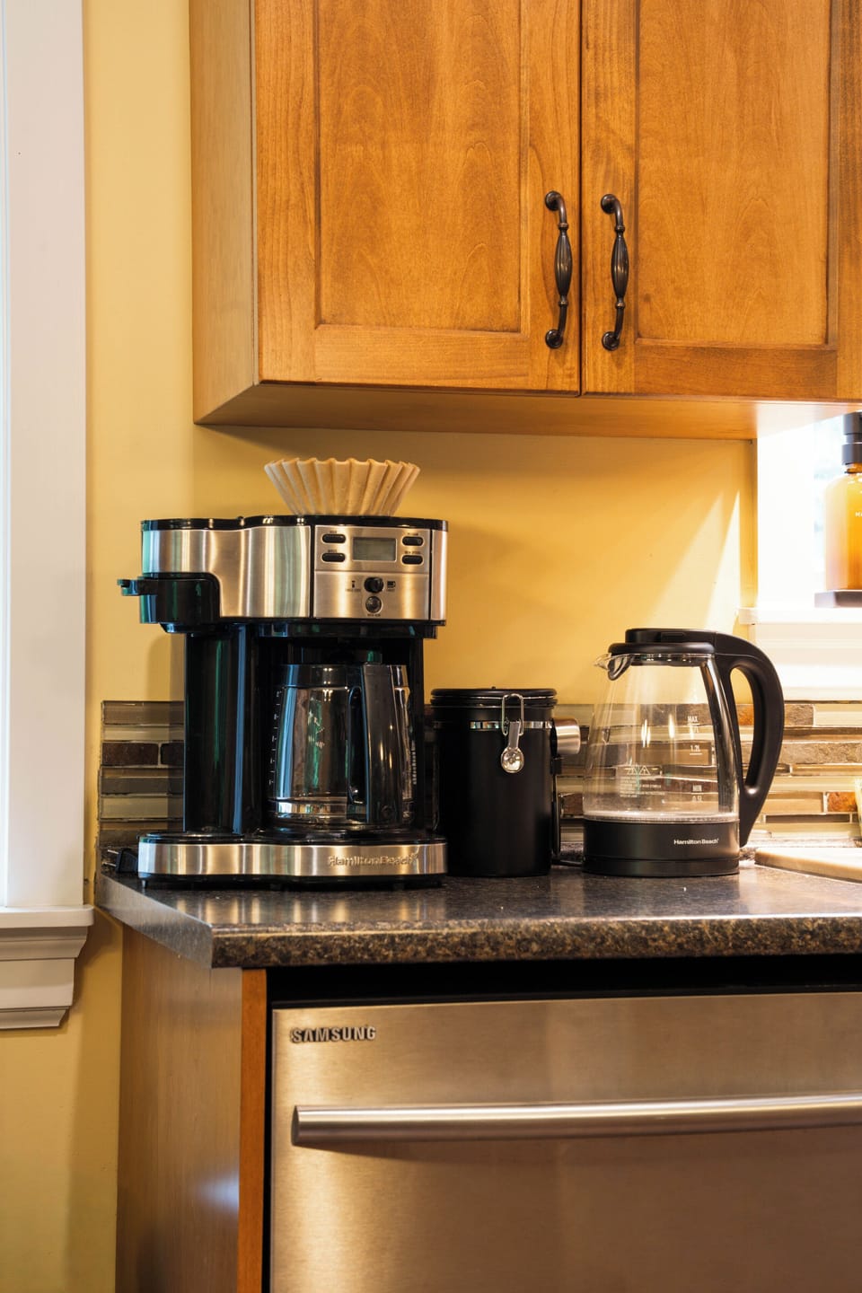 Convenient kitchen coffee station with coffee maker, kettle, and ground coffee