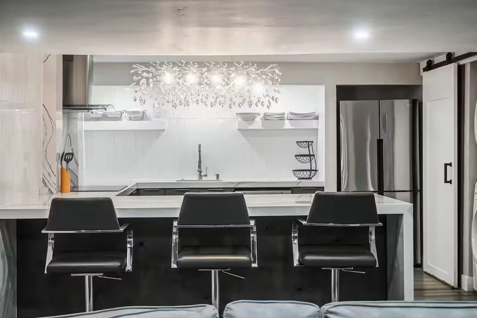 Modern fully equipped kitchen with spacious island and bar seating.