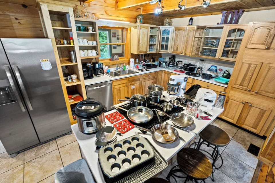 Chef's Kitchen with plenty of small appliances plus utensils, baking, cooking, mixing, serving, cutting, measuring and storage items. Plenty of dinnerware including plates, bowls, glasses, mugs, and silverware. Specific items may change over time. 