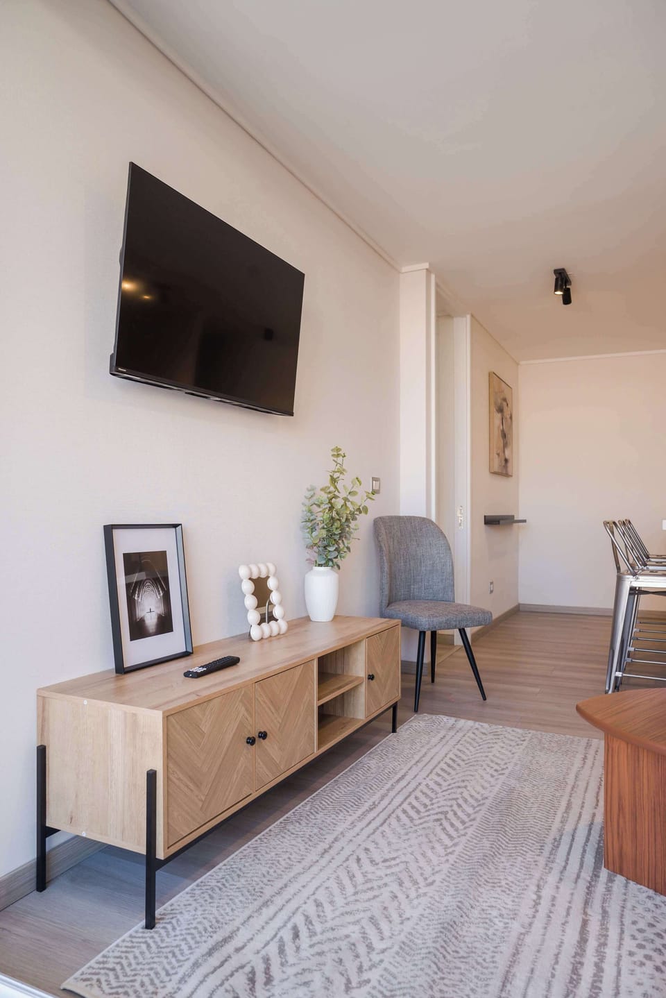 Cozy living area with modern decor and ample natural light, perfect for relaxation.