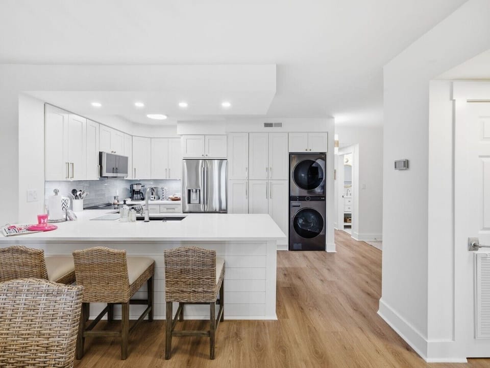 Convenient in-unit laundry tucked seamlessly into the kitchen area