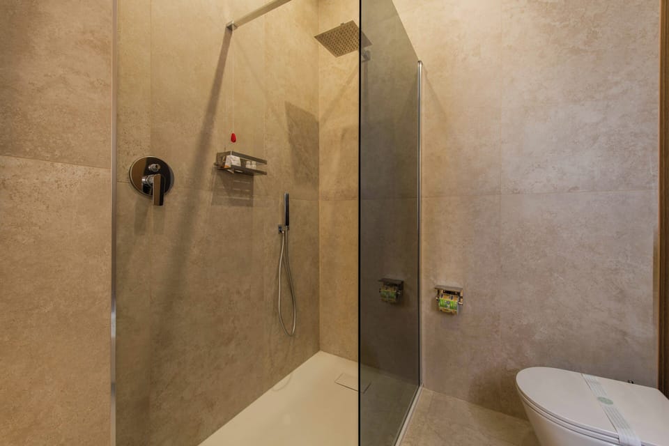 Luxury Double Room, City View | Bathroom | Shower, hair dryer, slippers, towels