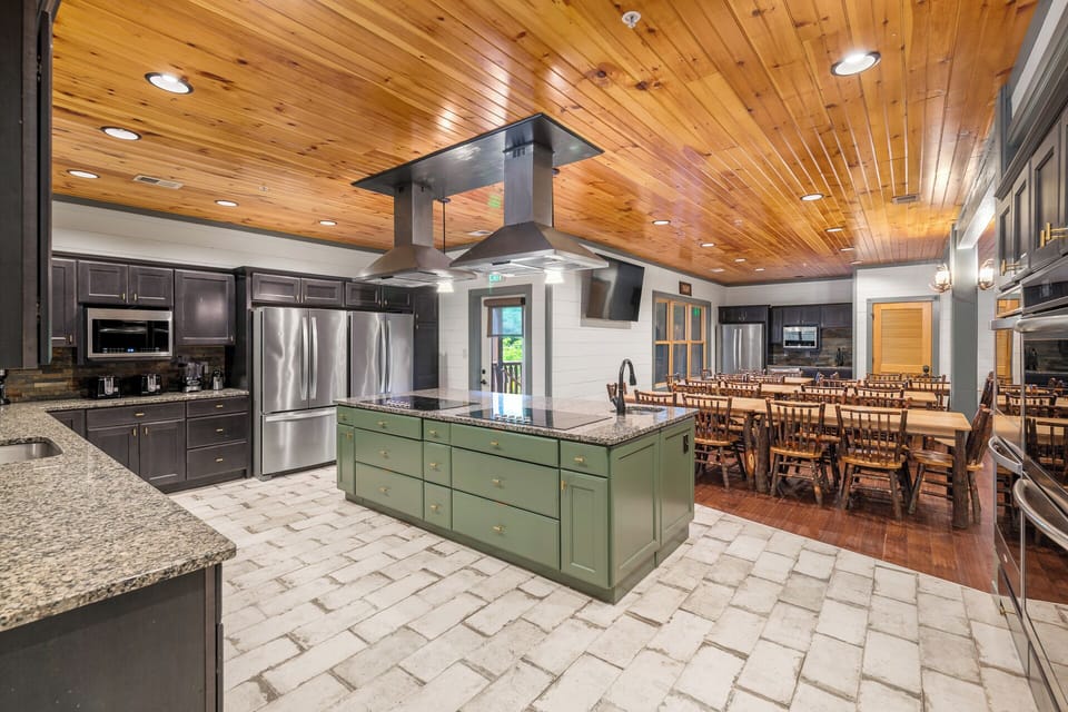 Four ovens, two stove tops, three dishwashers, three fridge/freezers and counter space built for feeding a crowd. Whether you're catering in or cooking together, this kitchen handles 60 guests without a bottleneck.
