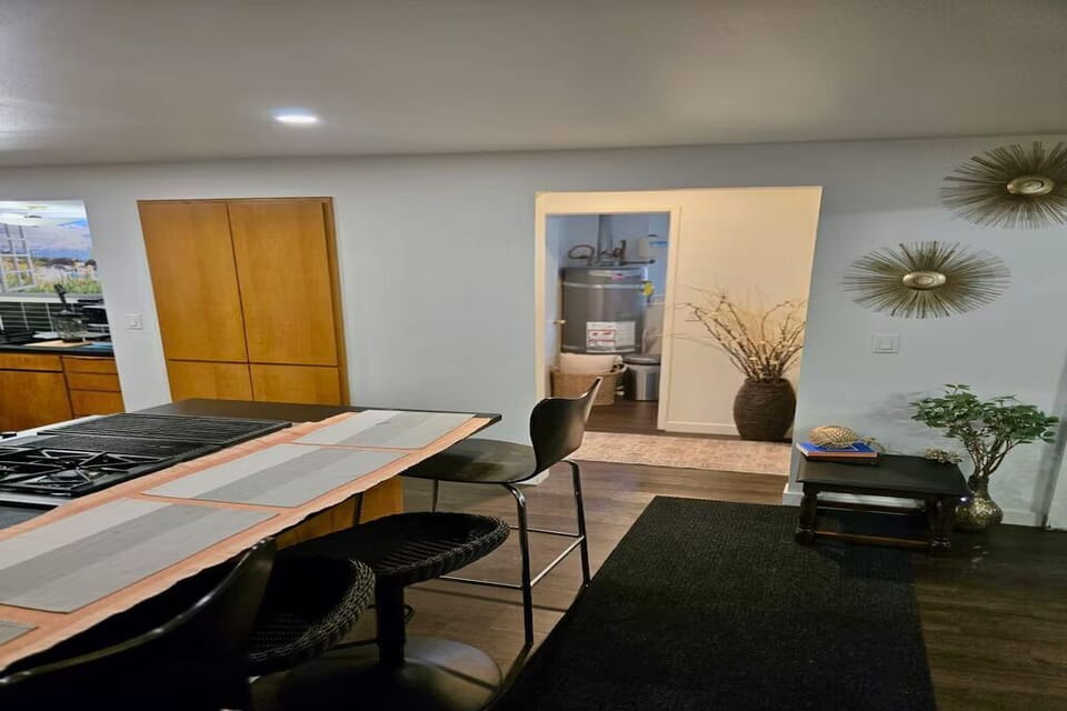 Modern kitchen with a spacious island, gas range, and ample prep space. The open layout flows into the dining area, making it easy to cook, dine, and spend time together in one welcoming space.