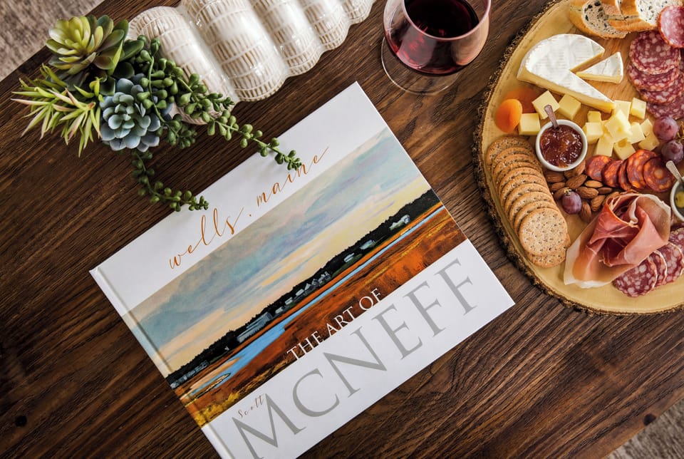 Decorative coastal-inspired coffee table styling with a charcuterie display and welcoming touches.