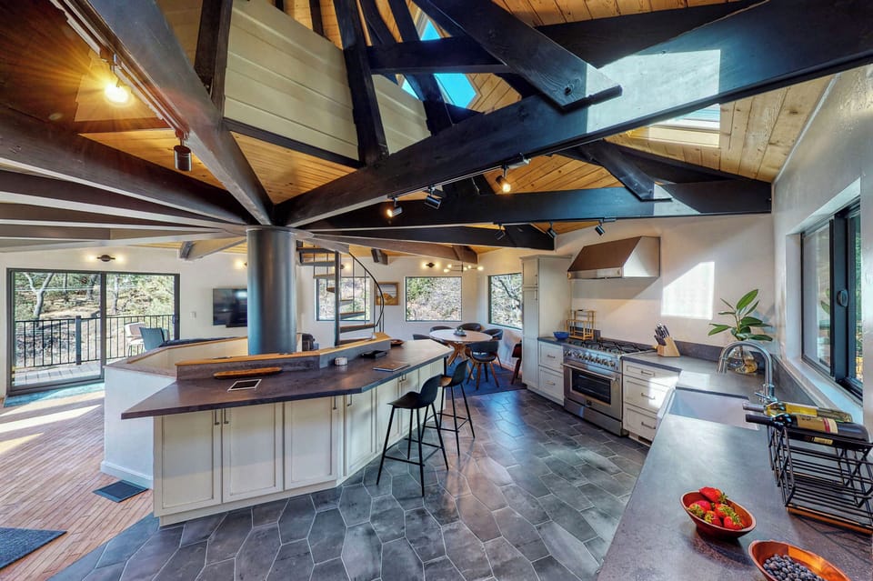 Fully stocked kitchen and island work station. Lake view across the living area.