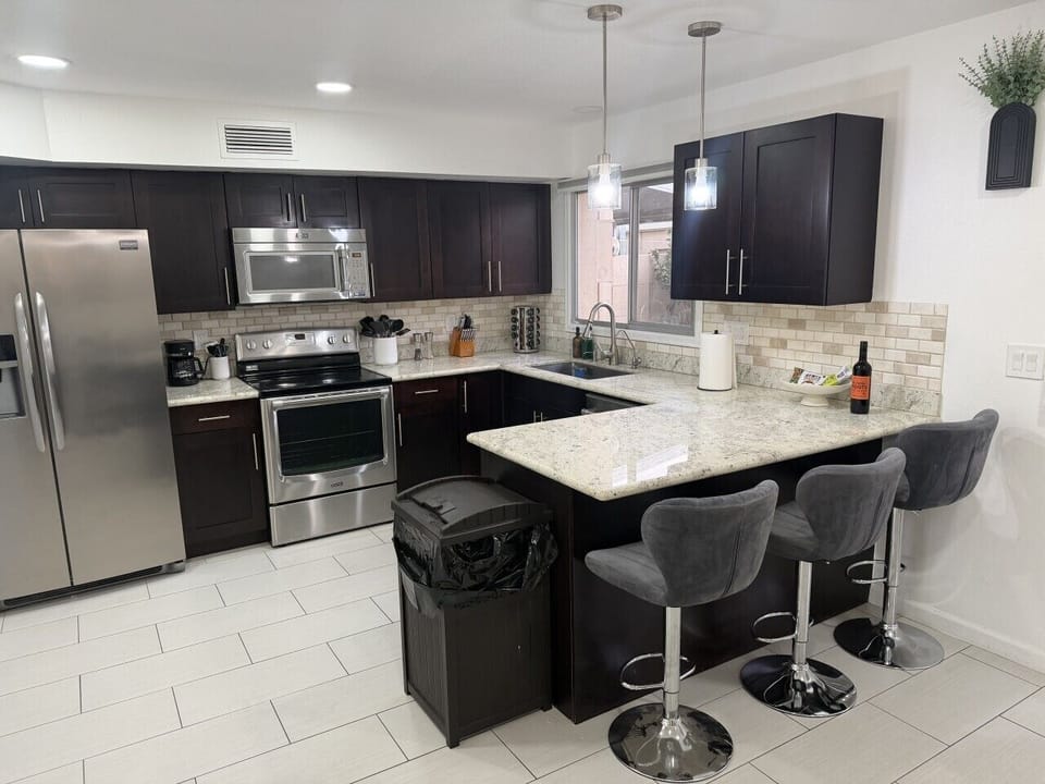 Fully equipped kitchen with island and bar stool seating