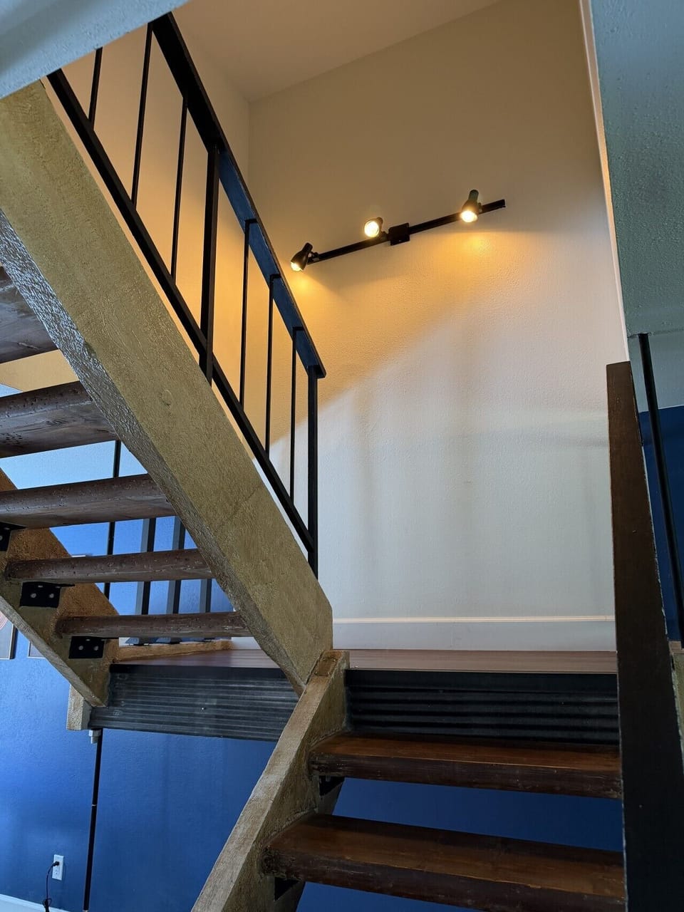 Staircase Leading to Upstairs Bedrooms with Modern Lighting