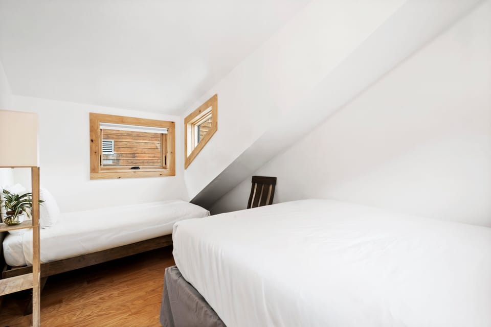 Cozy guest room two with queen bed and single bed.