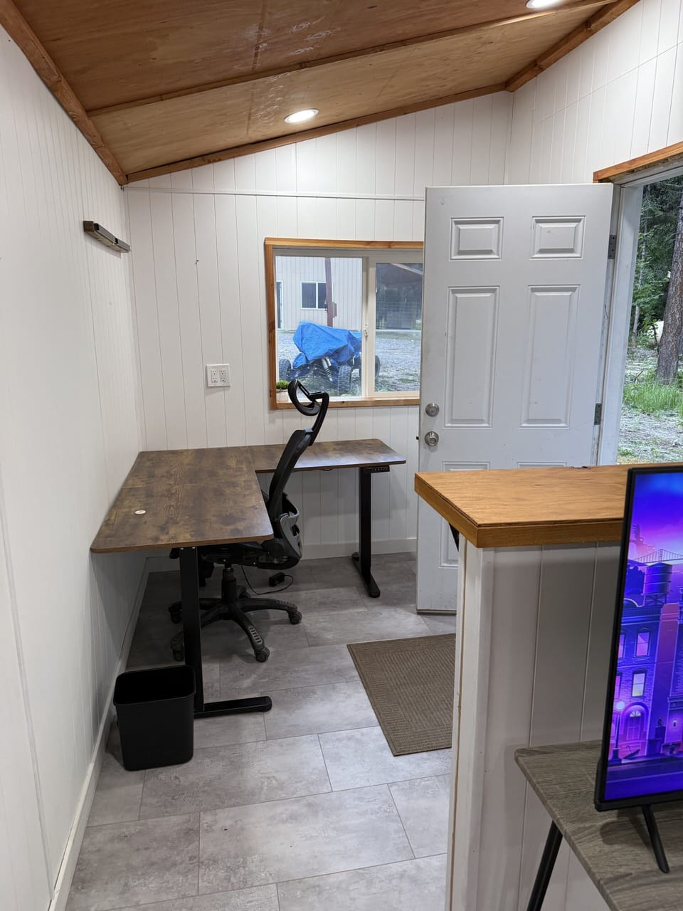 Bright entry nook with two desks and a cozy vaulted wood ceiling