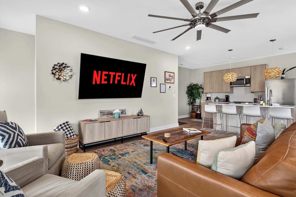 Living Room: Cozy couches and club chairs for reading, stream your shows on this 75 in TV or just relax!