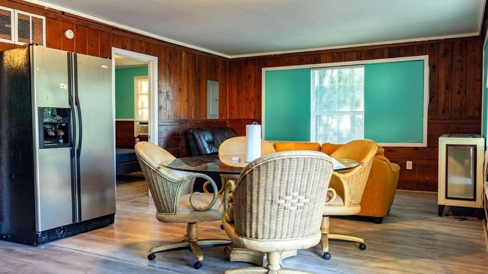 Dining and living area with refrigerator and seating