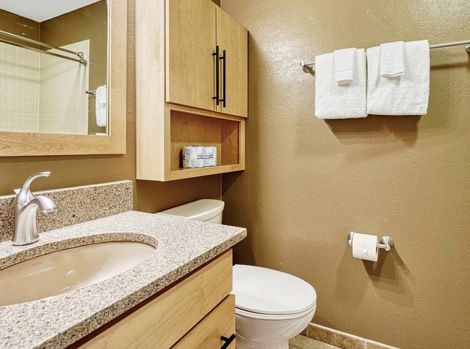 The final ensuite offers a single vanity & shower/tub combo​