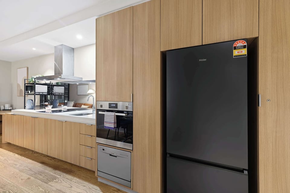 Fully-equipped kitchen with all the essentials for your stay including cookware, utensils, microwave, oven, stovetop, kettle and fridge.