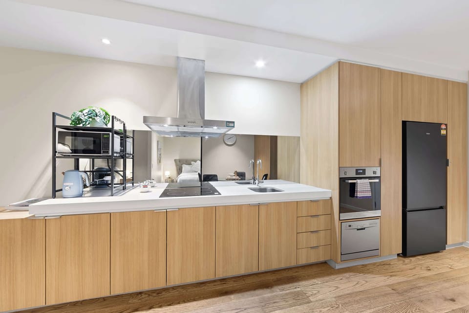 Fully-equipped kitchen with all the essentials for your stay including cookware, utensils, microwave, oven, stovetop, kettle and fridge.