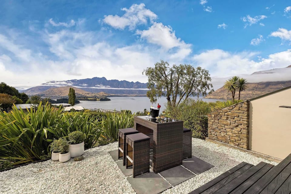 Outdoor Lounge: Sip cocktails with stunning lake and mountain views in this elegant alfresco retreat!