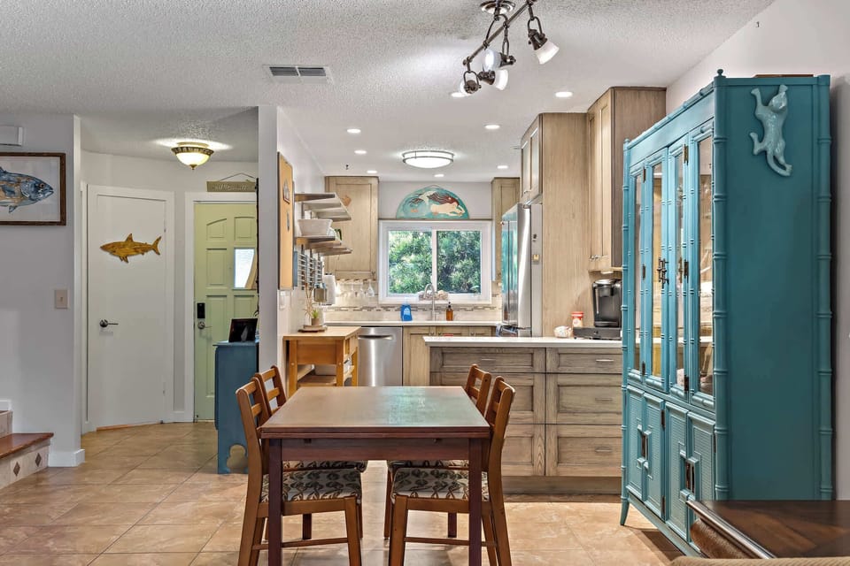 Cozy kitchen and dining area with natural light and unique coastal decor.