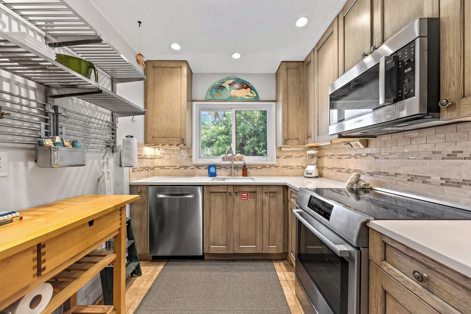 Modern kitchen with stainless steel appliances and natural wood cabinetry