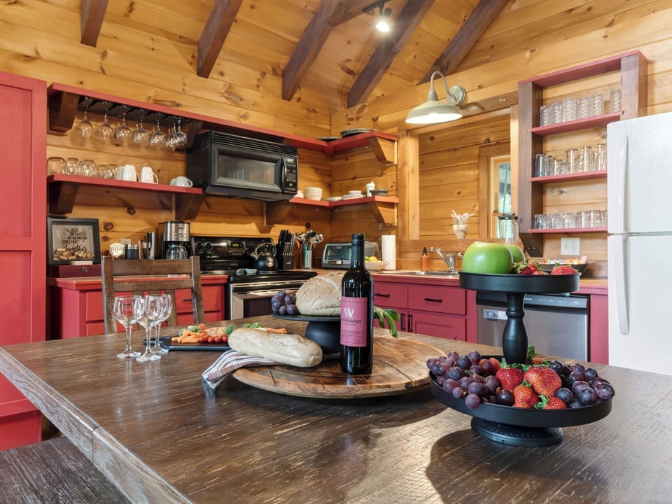 Warm cabin dining with vaulted wood ceilings, rustic charm, and a cozy fireplace nearby.