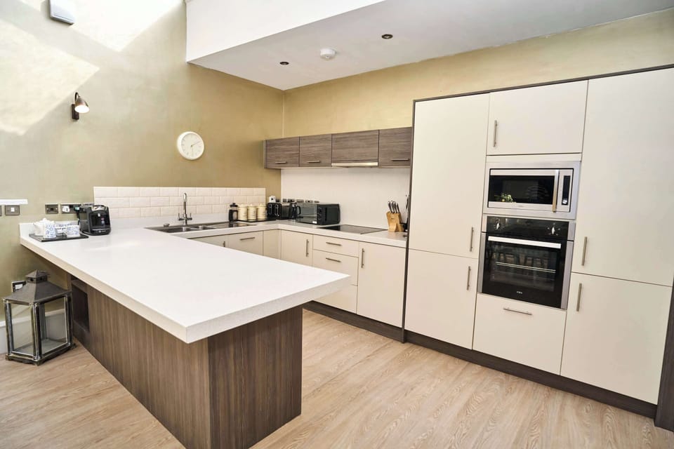 The heart of the home. Our sleek, sun-filled kitchen is designed for convenience and style, making it the perfect spot to brew your morning coffee or whip up a gourmet dinner.