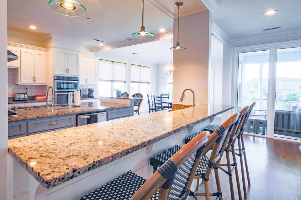 The kitchen features a central island as well as mulitple counters to prepare and serve your meals.