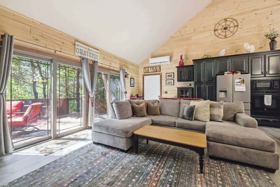 Vaulted ceilings and wall-to-wall windows create a bright, open gathering space.