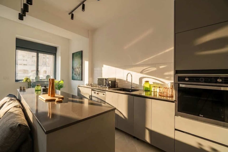 Sleek fully equipped kitchen with generous counter space and a clean contemporary design.