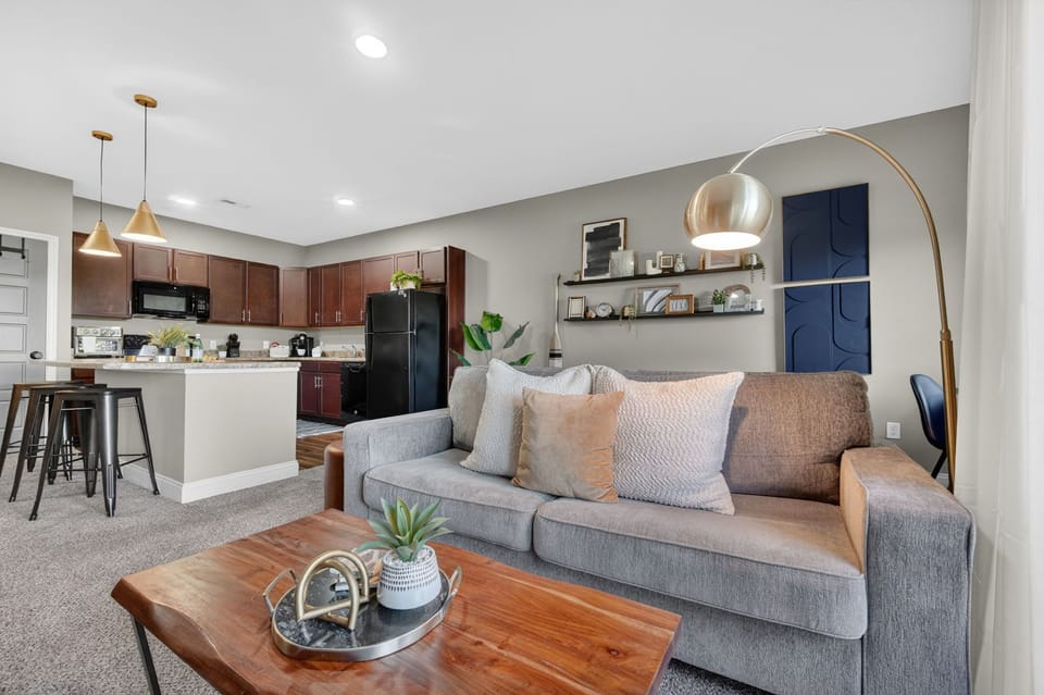 Bright open-concept living room and kitchen with modern decor and bar seating