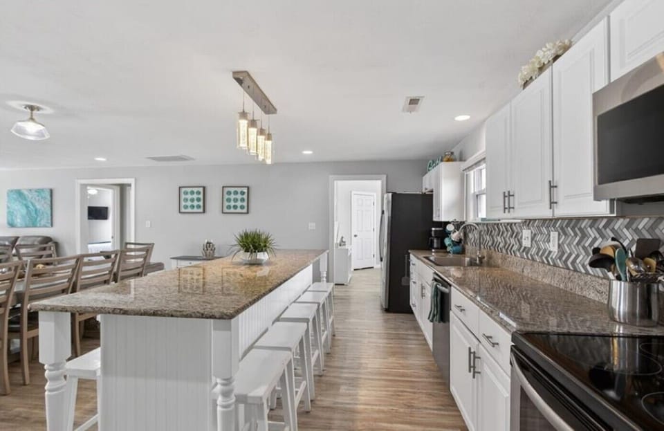 Gather around the oversized island for morning coffee, afternoon snacks, and family meals after a day on the water.