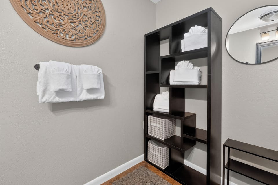 Crisp, fluffy towels and thoughtful storage await you in this spa-inspired space, where everything you need is elegantly arranged for your comfort and convenience.