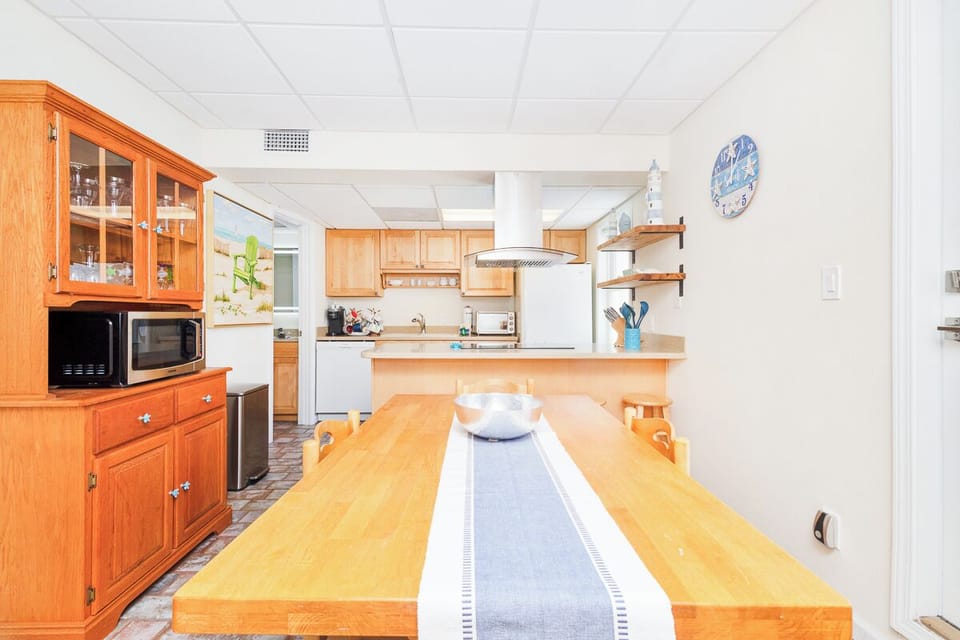 Gather around a spacious kitchen where meals become memories. Warm wood cabinetry, modern appliances, and a generous prep island invite you to cook, share stories, and savor every moment together.
