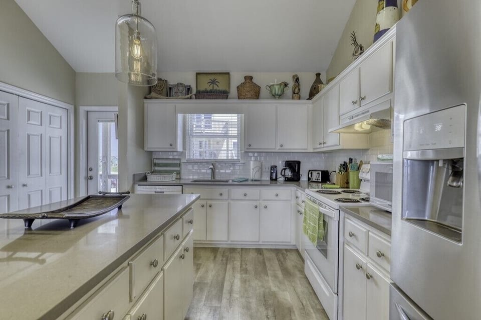 Bright, fully-equipped kitchen with stainless appliances, ample counter space, and charming décor—perfect for preparing your favorite meals during your stay.