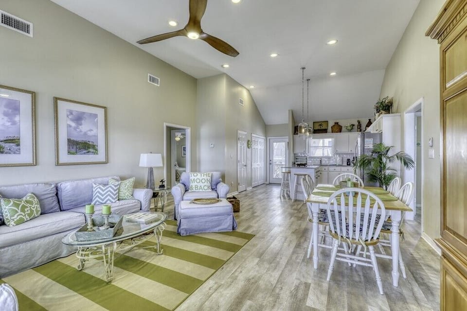 Step into your bright, breezy retreat with vaulted ceilings, coastal-chic furnishings, and an open layout that flows from living to dining to kitchen—perfect for your group getaway.