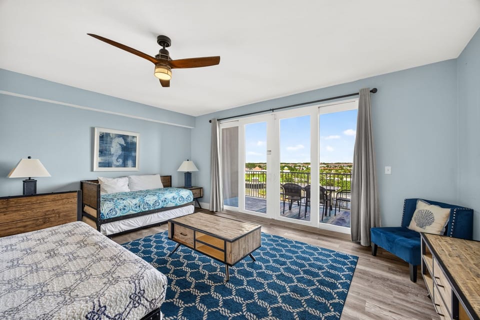 Step into your breezy retreat, where calming blue tones meet warm wood finishes and plenty of natural light. Your private balcony overlooks scenic views, perfect for morning coffee or sunset relaxation.