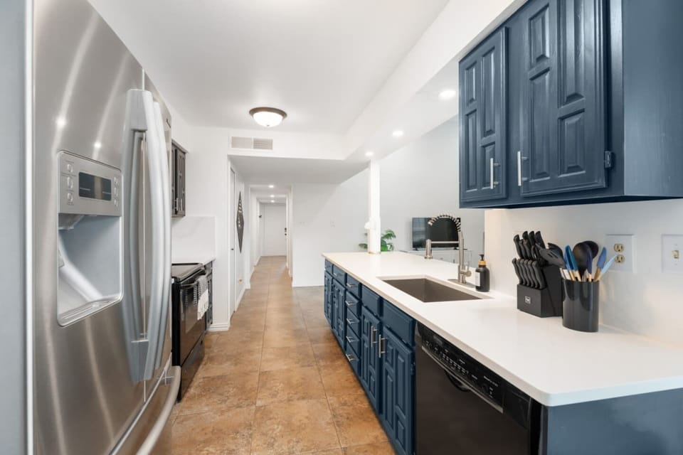 Modern kitchen with bold cabinetry and stainless steel appliances.