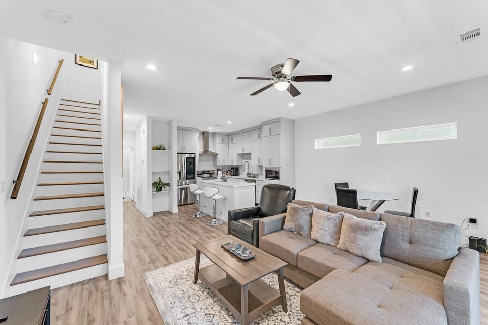 Bright open-concept layout connecting living, dining, and kitchen spaces ideal for families and groups to relax and reconnect.