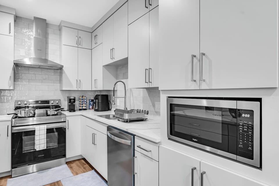 Luxury kitchen with premium finishes, oversized island with bar seating, and a seamless flow into the open living space—perfect for entertaining in style.