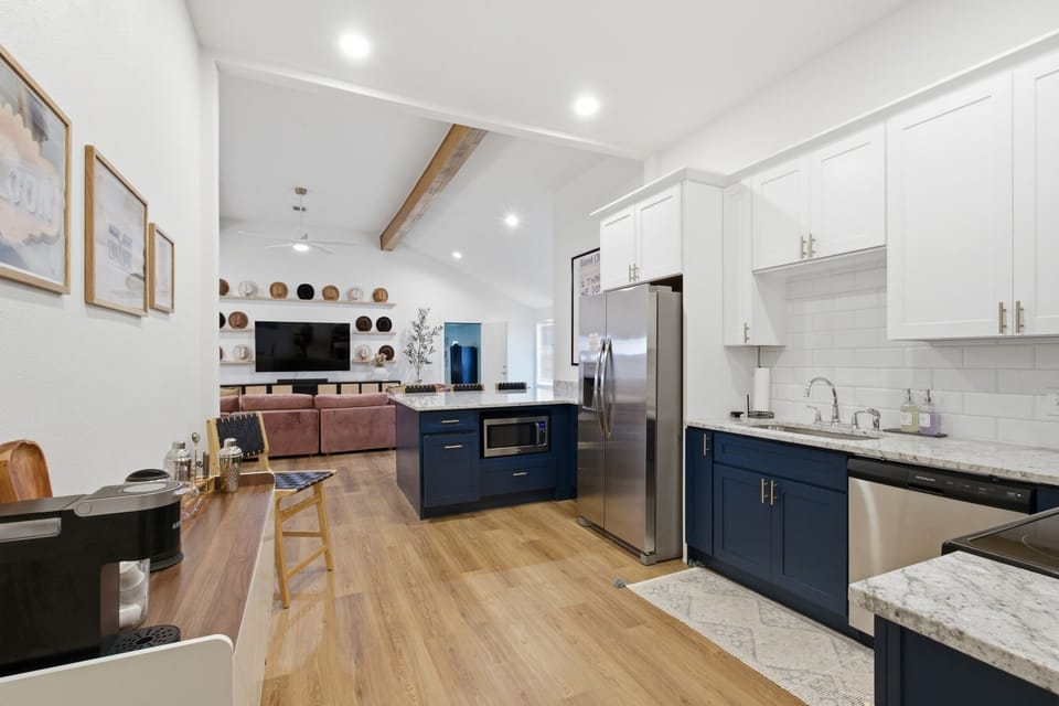 Wide kitchen and dining connection with hardwood floors and open-concept layout. Fully stocked for short and extended stays.