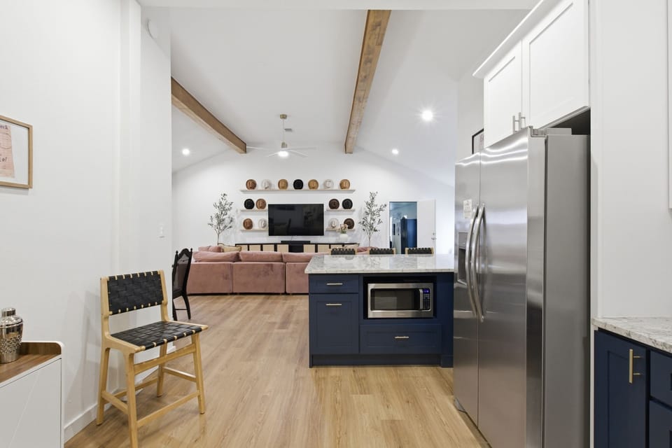 Kitchen pass-through with Microwave and full appliance counter. Open layout connects to dining and living areas.