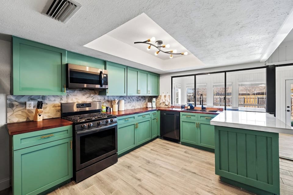 Cook like a chef in the fully stocked kitchen, boasting a large island, stainless steel appliances, and ample counter space.