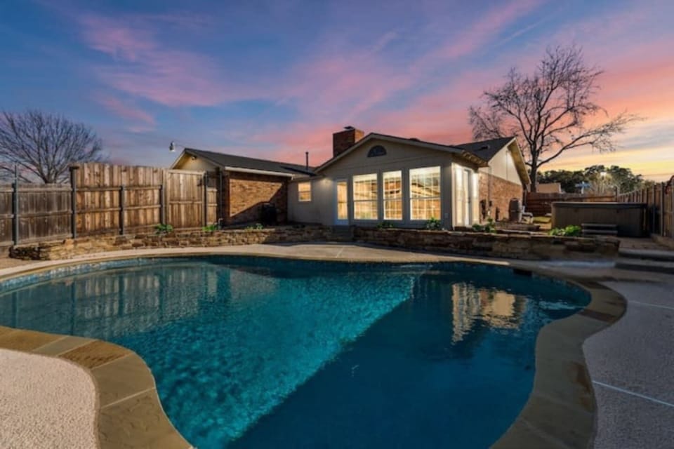 Private backyard oasis with sparkling pool, sun loungers, and direct access to the indoor bar—perfect for poolside entertaining.