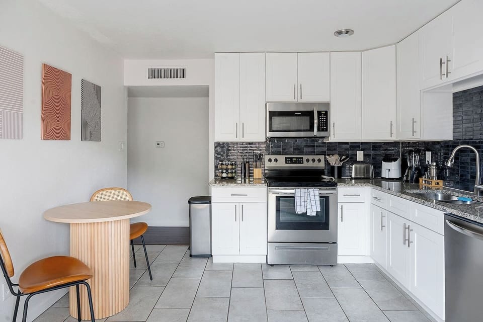 Cook with ease in this modern kitchen equipped with stainless steel appliances and a cozy dining nook, it is fully-stocked with all of the appliances, coffee, tea, and cooking necessities you will need!