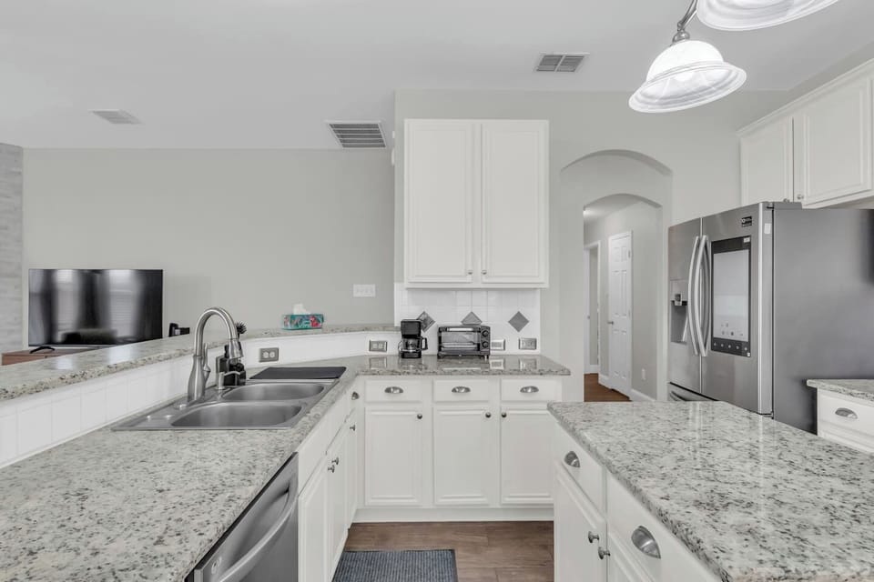 Stocked with cookware, pots, pans, dishes, silverware, and essential kitchen tools to support short and extended stays.